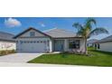 One story home with light gray siding, gray roof, and landscaping at 5108 Villa Crest Way, Auburndale, FL 33823