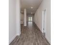 Long hallway with wood-look tile floor at 5108 Villa Crest Way, Auburndale, FL 33823