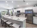 Spacious kitchen with island, stainless steel appliances, and white cabinets at 5435 Se 127Th Ln, Belleview, FL 34420