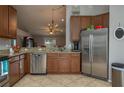 Spacious kitchen with stainless steel appliances and wood cabinets at 5791 Woodruff Way, Lakeland, FL 33812
