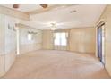 Bright living room featuring carpeted floor and large windows at 6683 Briarhill Ne Dr, Winter Haven, FL 33881
