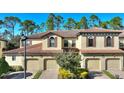 Three-story townhouse boasts a tile roof, two-car garage, and tasteful landscaping at 8205 Roseville, Davenport, FL 33896