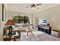 Bright and airy living room with a large sectional sofa and tile floors at 904 Charo Pkwy # 517, Davenport, FL 33897