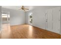 Living room with hardwood floors, large windows, and ceiling fan at 2473 Barbarossa, Deltona, FL 32738