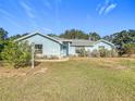 Ranch-style home with light blue exterior and a well-maintained lawn at 309 W Frederick Ave, Dundee, FL 33838