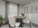Bright dining area with four chairs and wood table at 309 Wharf Way, Winter Haven, FL 33881