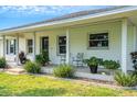 Inviting front porch with white columns and lush landscaping at 1730 Broken Arrow N Trl, Lakeland, FL 33813