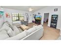 Open living room with sectional sofa and access to bedroom at 227 Ridgedale Dr, Lakeland, FL 33809