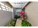 Covered walkway with pergola, lush landscaping, and a private gate at 3164 Stonewater Dr # 3164, Lakeland, FL 33803