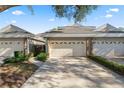 Front view of townhome community showcasing attached garages and landscaping at 3164 Stonewater Dr # 3164, Lakeland, FL 33803