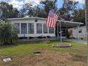 Landscaped yard with American flag and spacious driveway at 1610 Reynolds Rd # 211, Lakeland, FL 33801
