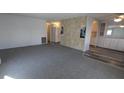 Spacious living room with carpet and view into kitchen at 1610 Reynolds Rd # 211, Lakeland, FL 33801