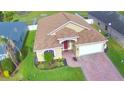 An aerial view of the home showcasing its landscaped front yard and brick driveway at 3226 Oak Tree Ln, Winter Haven, FL 33884