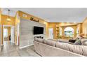 Inviting living room with wood accent wall, comfortable seating, and tile flooring at 4617 S Devon Ave, Lakeland, FL 33813