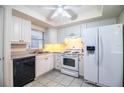 Bright kitchen featuring white cabinetry, modern appliances, and tile flooring at 540 Kelsey St, Lakeland, FL 33803