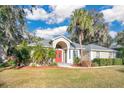 Beautiful home exterior with red front door and lush landscaping at 6818 Hayter Drive, Lakeland, FL 33813