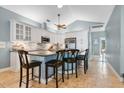 Modern kitchen with white cabinets, granite countertops, stainless steel appliances, and a breakfast bar at 6818 Hayter Drive, Lakeland, FL 33813