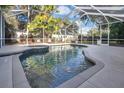 Inviting pool with a spa, surrounded by a screened enclosure, perfect for relaxation at 6818 Hayter Drive, Lakeland, FL 33813