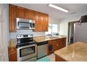Updated kitchen featuring stainless steel appliances and granite countertops at 3915 Pipkin Creek Rd, Lakeland, FL 33811
