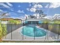 Inviting kidney-shaped pool with a safety fence and backyard access at 3915 Pipkin Creek Rd, Lakeland, FL 33811