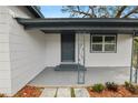 Inviting front porch with a dark gray door and ornate metal railings at 4925 Magnolia Ave, Mulberry, FL 33860