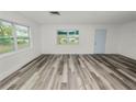 Bright and airy living room featuring wood-look flooring and neutral walls at 4925 Magnolia Ave, Mulberry, FL 33860