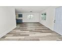 Spacious living area with vinyl flooring and a view into the kitchen at 4925 Magnolia Ave, Mulberry, FL 33860