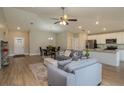 Open living room with hardwood floors, neutral walls, and a kitchen at 5435 Carmen Ln, Lakeland, FL 33810