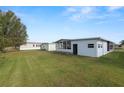 Spacious backyard with green grass and mobile homes at 2055 S Floral Ave # 146, Bartow, FL 33830