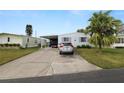 Mobile home with carport, golf cart, and driveway at 2055 S Floral Ave # 146, Bartow, FL 33830