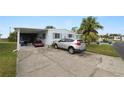 Mobile home with carport, golf cart, and driveway at 2055 S Floral Ave # 146, Bartow, FL 33830