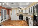 Updated kitchen with stainless steel appliances and terracotta tile floors at 4409 Hallam Hill Ln, Lakeland, FL 33813
