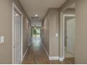 Hallway with wood-look flooring and access to bedrooms and living areas at 1021 Rhodes S Rd, Haines City, FL 33844