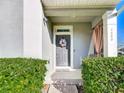 Welcoming front porch with decorative wreath and elegant gray door at 4800 Nathan Hale Blvd, Saint Cloud, FL 34769