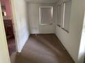 Empty spare bedroom with carpeted floor and two windows at 142 Park Blvd, New Smyrna Beach, FL 32168