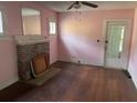 Living room with hardwood floors, fireplace, and built-in shelving at 142 Park Blvd, New Smyrna Beach, FL 32168