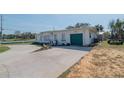 Ranch-style home with green garage door at 2200 S Peninsula Dr, Daytona Beach, FL 32118