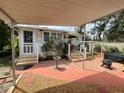 Quaint backyard with patio, landscaping, and fire pit area at 607 N Dixie Fwy, New Smyrna Beach, FL 32168