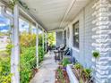 Inviting front porch with seating area, surrounded by greenery at 603 N Pine St, New Smyrna Beach, FL 32169