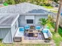 Relaxing patio with comfortable seating and fire pit at 603 N Pine St, New Smyrna Beach, FL 32169