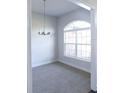 Bright dining room with chandelier and arch window at 243 Lagoon Mist Ct, Oak Hill, FL 32759