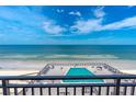 Ocean view from condo balcony with pool in foreground at 4139 S. Atlantic Ave # B504, New Smyrna Beach, FL 32169