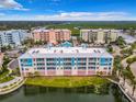 Aerial view of condo building, pool, and surrounding area at 1 Riverwalk Dr # 302, New Smyrna Beach, FL 32169