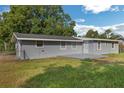 Rear view of house with deck and fenced backyard at 1355 Powers Ave, Daytona Beach, FL 32117