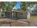 Side view of the house showing screened porch and walkway at 1355 Powers Ave, Daytona Beach, FL 32117
