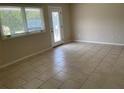 Living room with tile floors, large window, and glass French door at 4513 Saxon Dr, New Smyrna Beach, FL 32169
