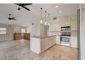 Modern kitchen with white cabinets and granite island at 6468 Engram Rd, New Smyrna Beach, FL 32169