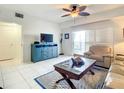 Living room with a TV, comfy couch and access to a balcony at 5300 S Atlantic # 1-604, New Smyrna Beach, FL 32169