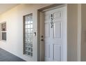 Condo building entrance with white door and glass block window at 5300 S Atlantic Ave # 8502, New Smyrna Beach, FL 32169