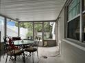 Screened porch with table and chairs, overlooking backyard at 806 E 2Nd Ave, New Smyrna Beach, FL 32169